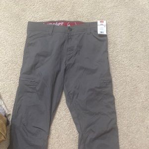 Stretchy wrangler pants. Side pockets with zippers. Also regular pockets.